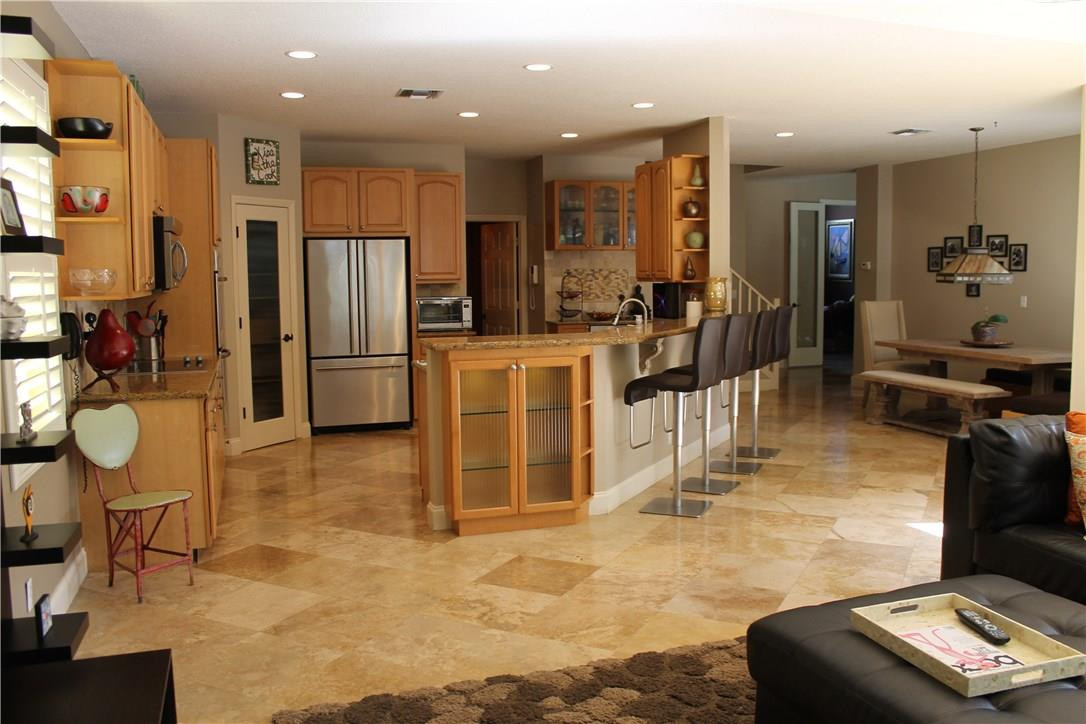 21491 Halstead Drive Boca Raton, FL 33428 - Photo 7 of 35 a kitchen with stainless steel appliances kitchen island granite countertop a refrigerator and cabinets