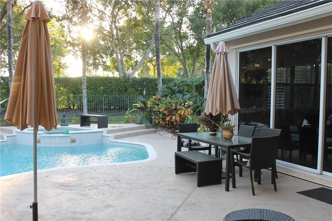 21491 Halstead Drive Boca Raton, FL 33428 - Photo 8 of 35 a view of a patio with table and chairs and potted plants
