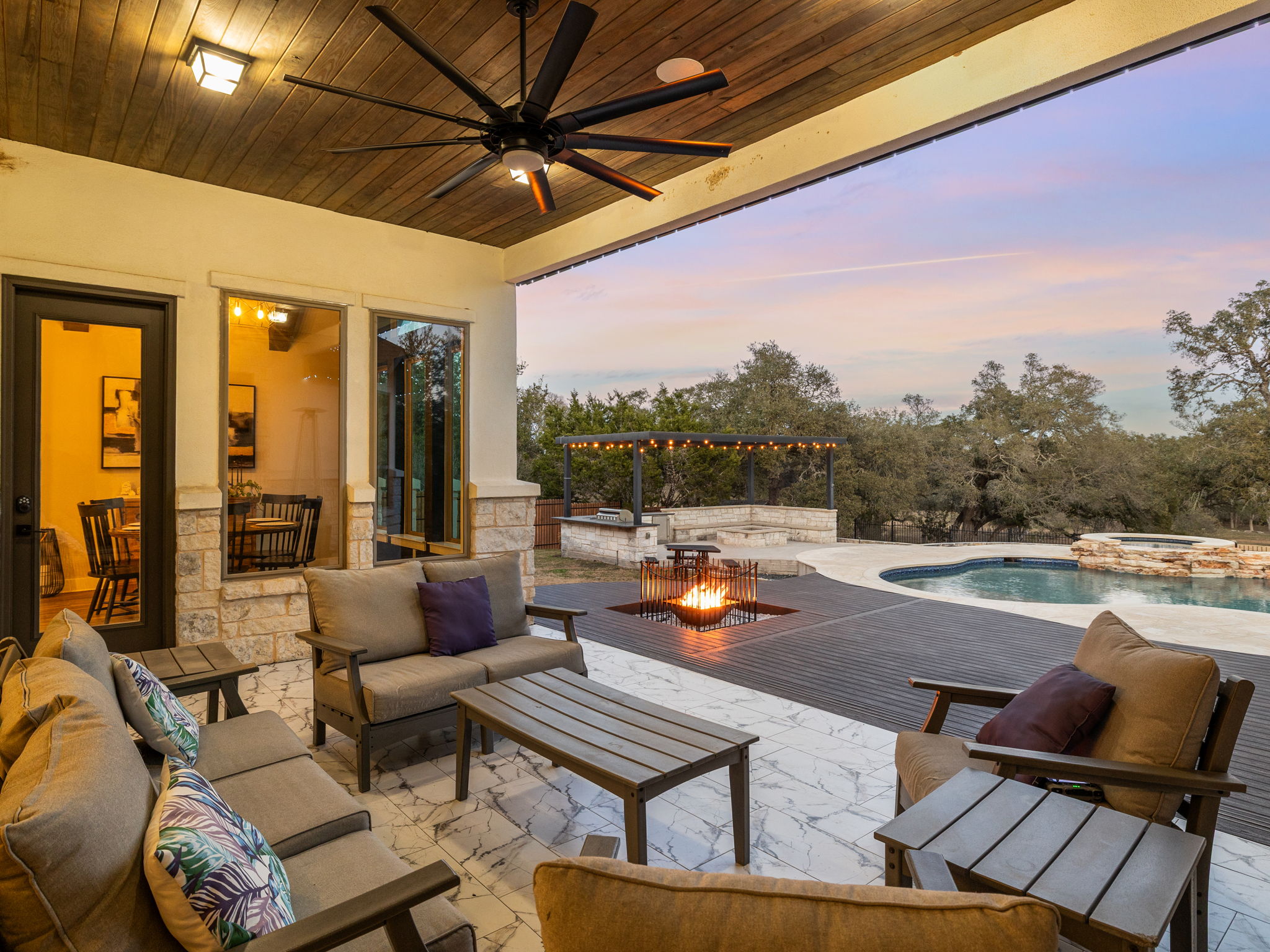 901 Clark Cove Road Buda, TX 78610 - Photo 31 of 37 View of patio / terrace with an outdoor living space with a fire pit, ceiling fan, a pool with connected hot tub, and a pergola