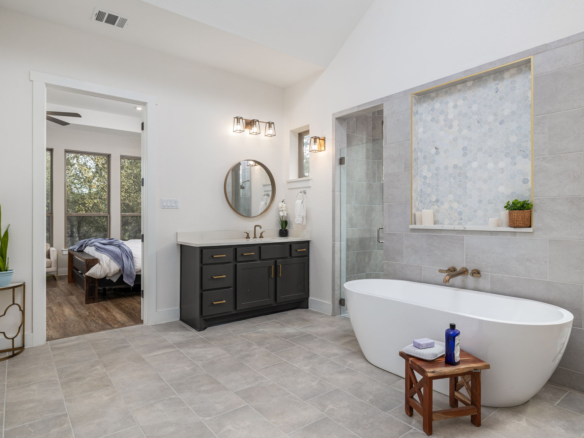 901 Clark Cove Road Buda, TX 78610 - Photo 8 of 37 Bathroom featuring vanity, a shower stall, a freestanding tub, vaulted ceiling, and tile walls