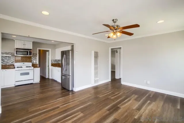a view of a kitchen with a stove cabinets and wooden floor