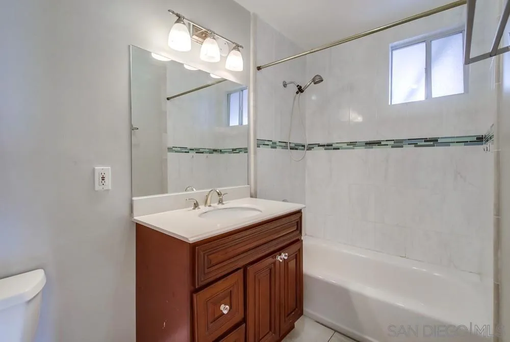 6327 Newsome Drive San Diego, CA 92115 - Photo 14 of 24 a bathroom with a sink mirror vanity and toilet