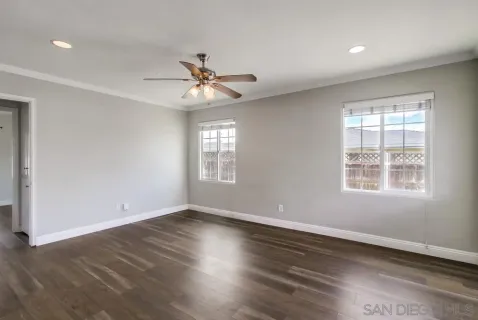 wooden floor in an empty room with a window