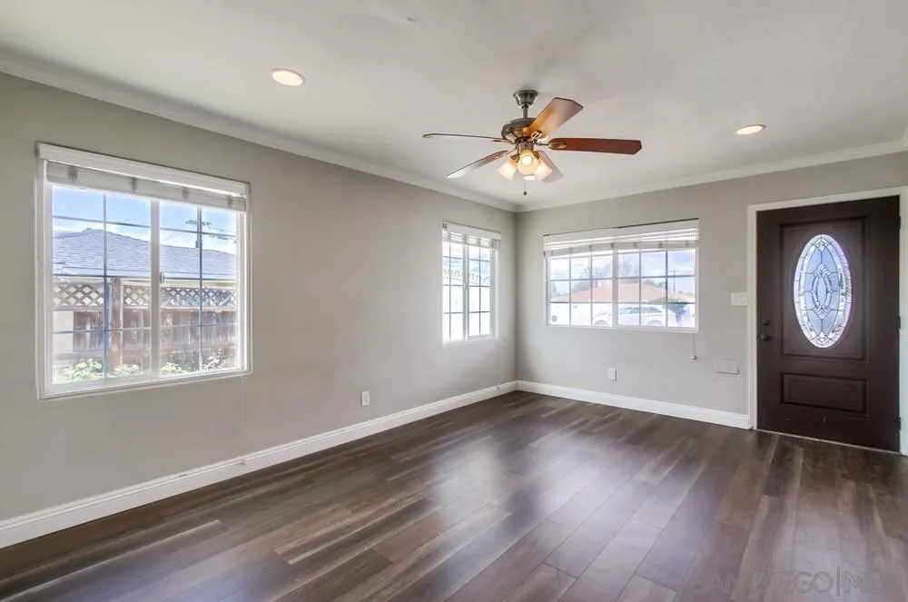 6327 Newsome Drive San Diego, CA 92115 - Photo 4 of 24 a view of an empty room with wooden floor and window