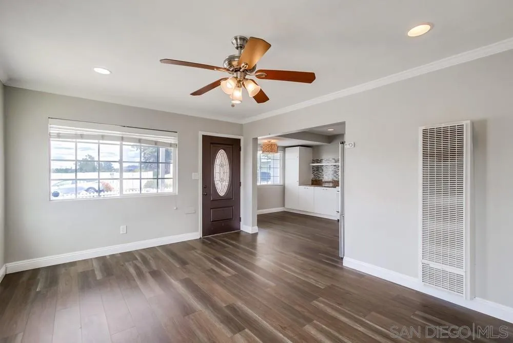 6327 Newsome Drive San Diego, CA 92115 - Photo 5 of 24 a view of an empty room with a window and wooden floor