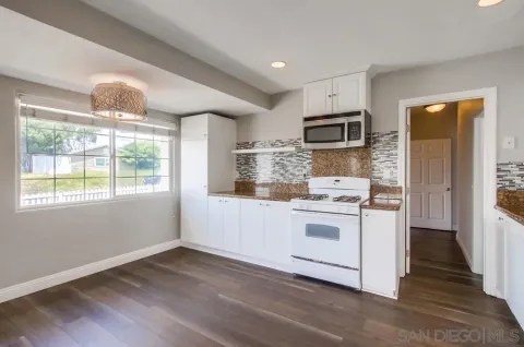 a kitchen with a stove a sink and a microwave