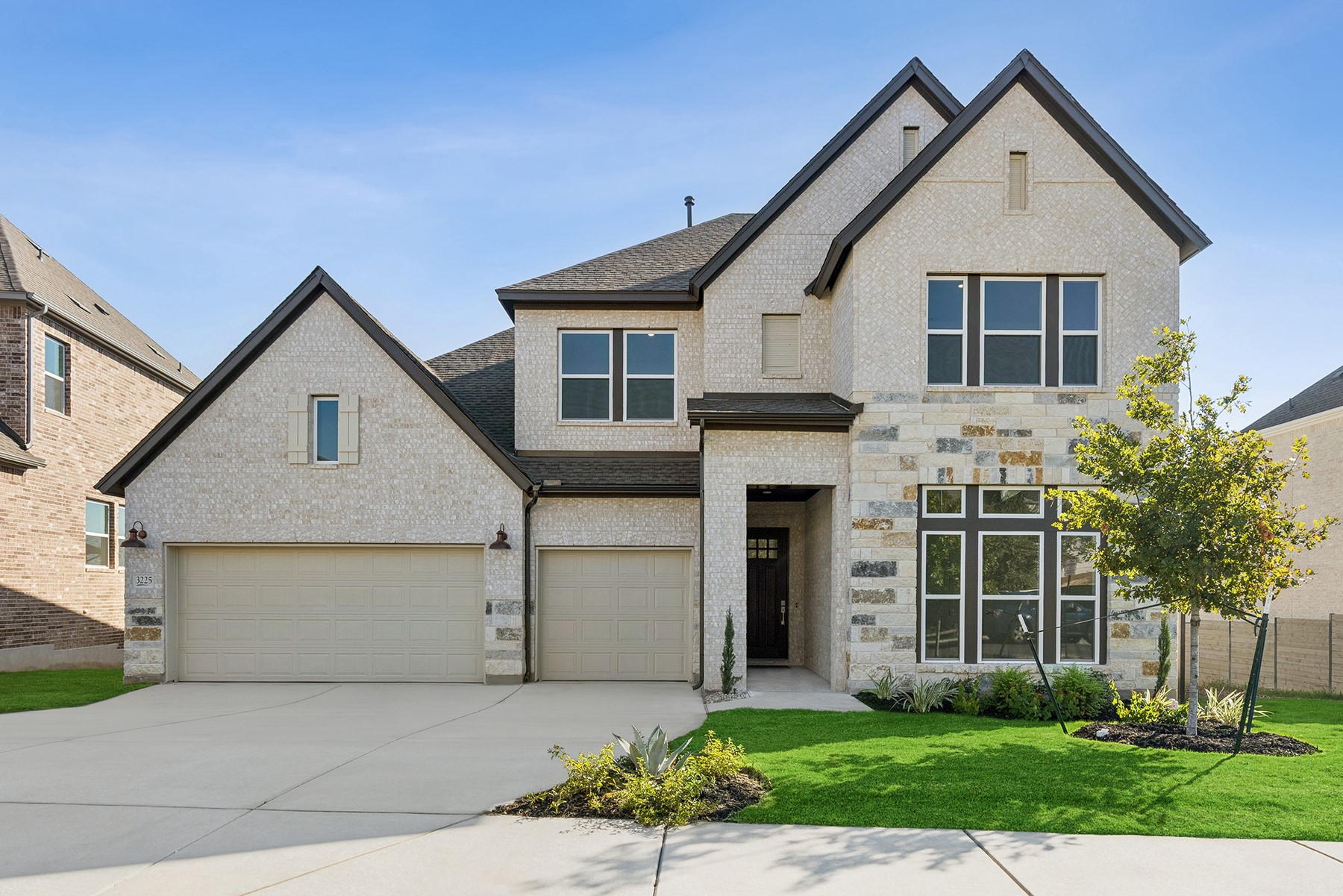 a front view of a house with a yard and garage