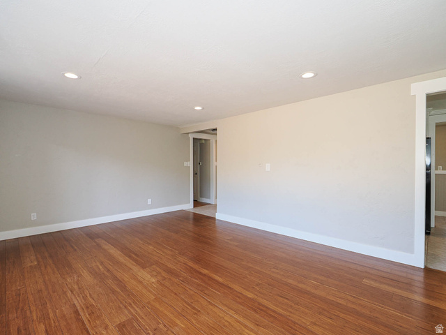 154 East 3000th Street South Bountiful, UT 84010 - Photo 9 of 37 Spacious room featuring wood-finish flooring, recessed lighting, neutral wall tones, and white trim molding