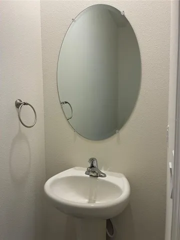 a bathroom with a sink a toilet and mirror
