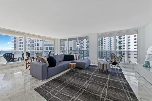 a living room with furniture or couch and two windows
