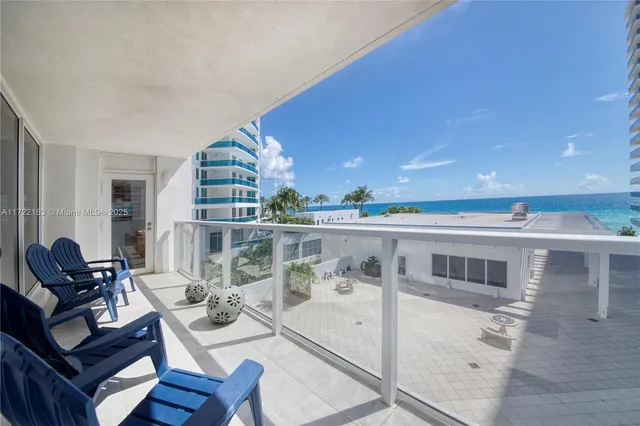 a living room with furniture a rug and a potted plant