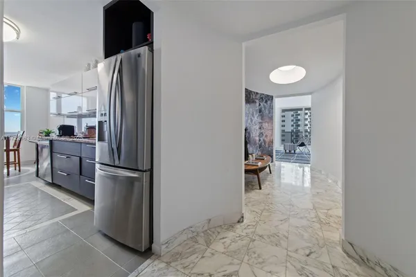 a kitchen with a refrigerator and a sink