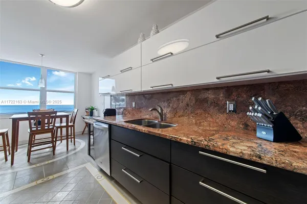 a kitchen with granite countertop lots of counter top space and dining table