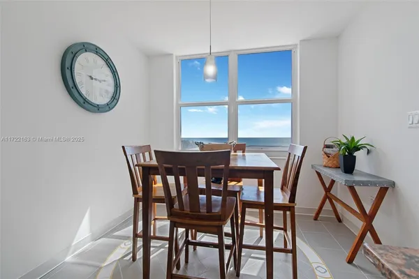 a view of a dining room with furniture and window