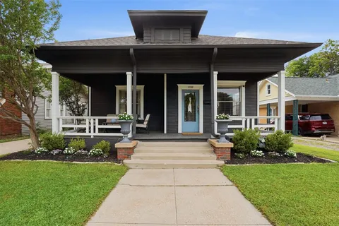 a view of a house with sitting area and garden