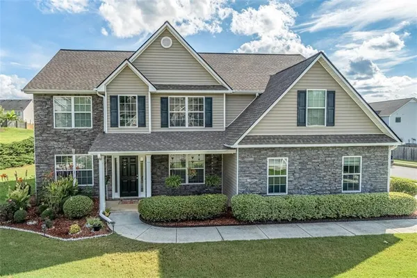 a front view of a house with a yard