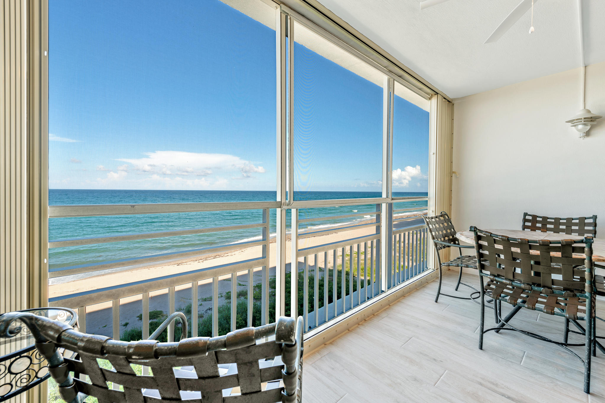 900 Ocean Drive, Unit 403 Juno Beach, FL 33408 - Photo 1 of 15 a view of a chairs and table in the balcony