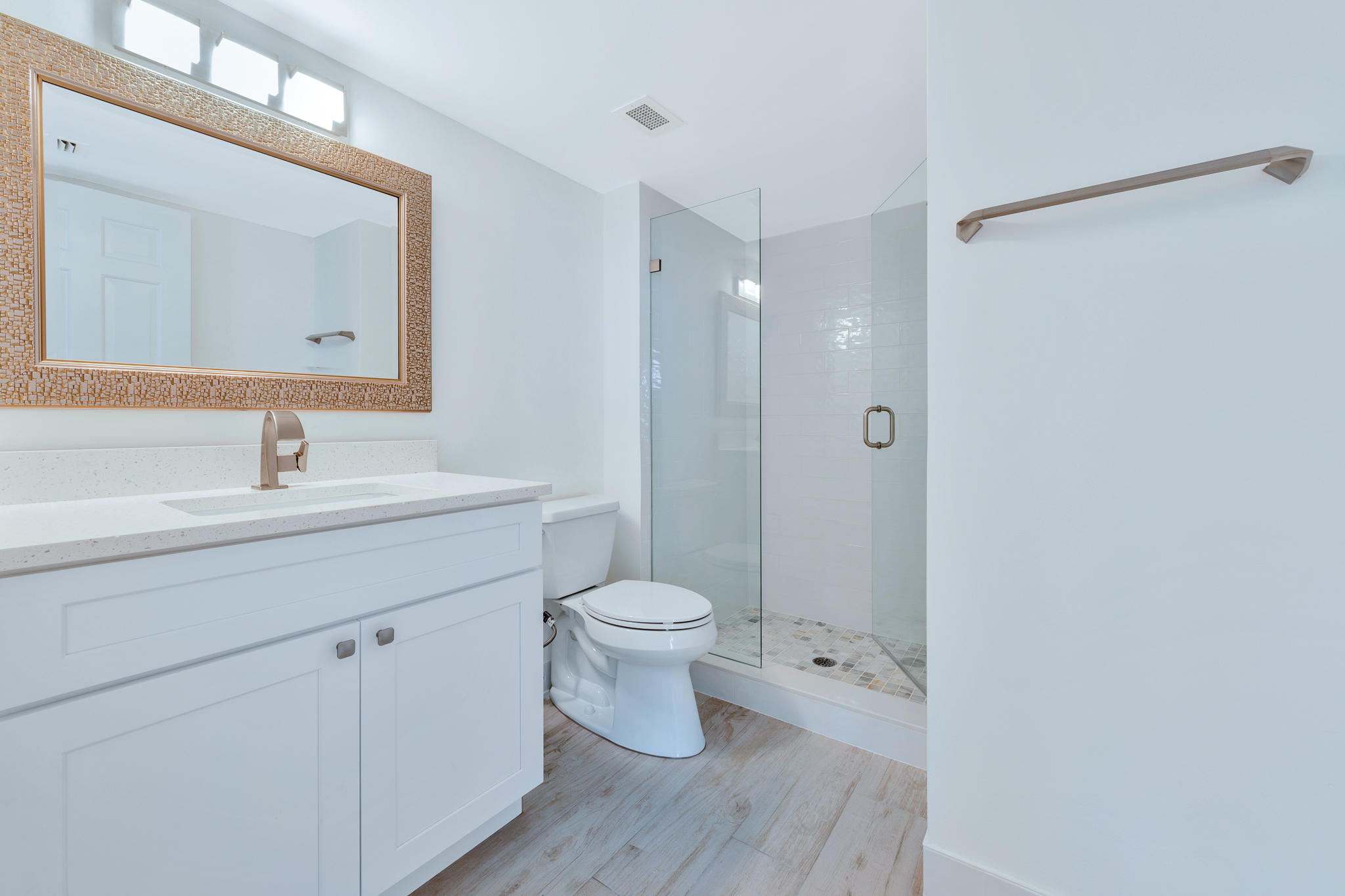 900 Ocean Drive, Unit 403 Juno Beach, FL 33408 - Photo 7 of 15 a bathroom with a sink a toilet a shower and a mirror