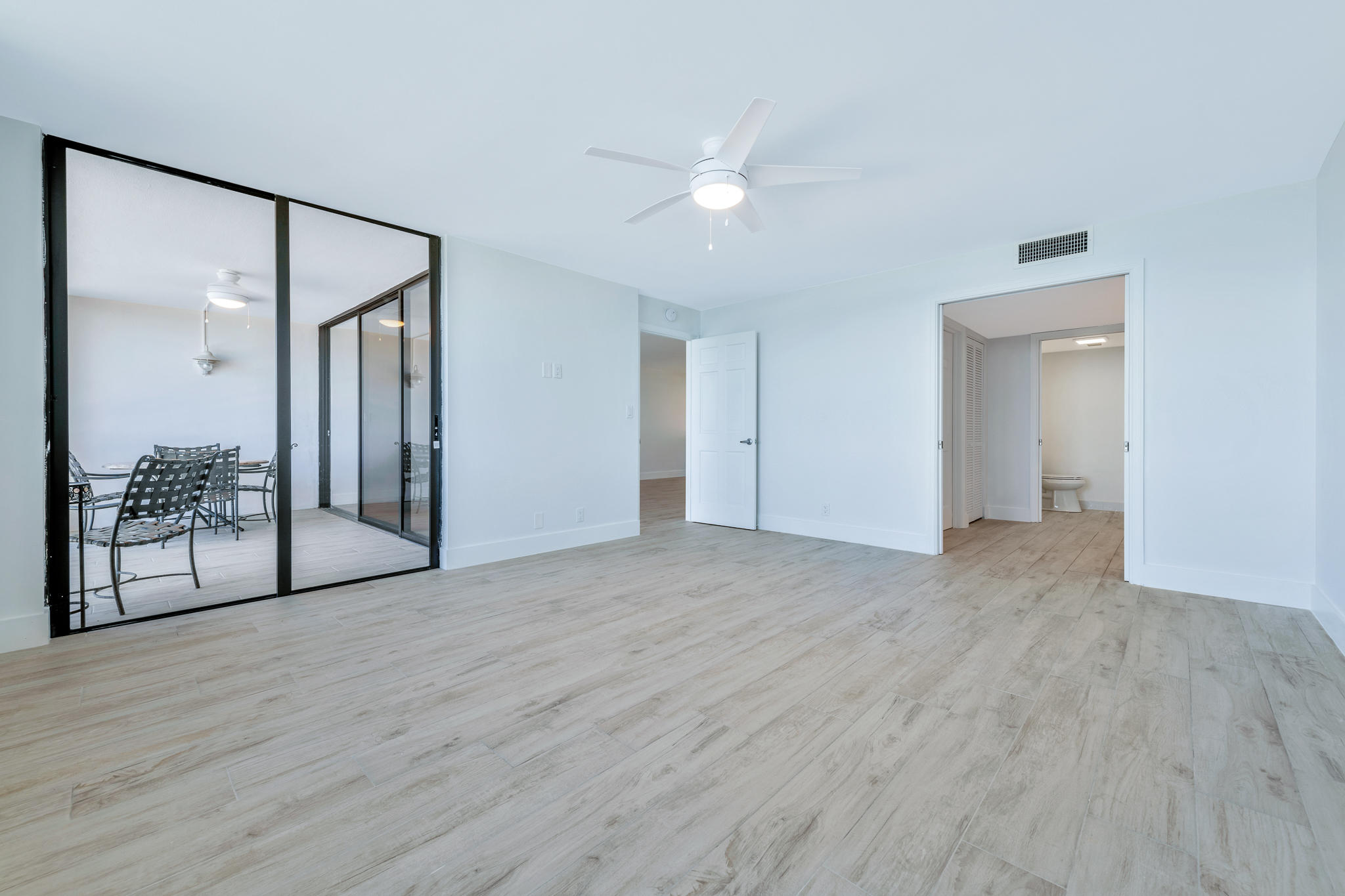 900 Ocean Drive, Unit 403 Juno Beach, FL 33408 - Photo 9 of 15 a view of an empty room with glass door