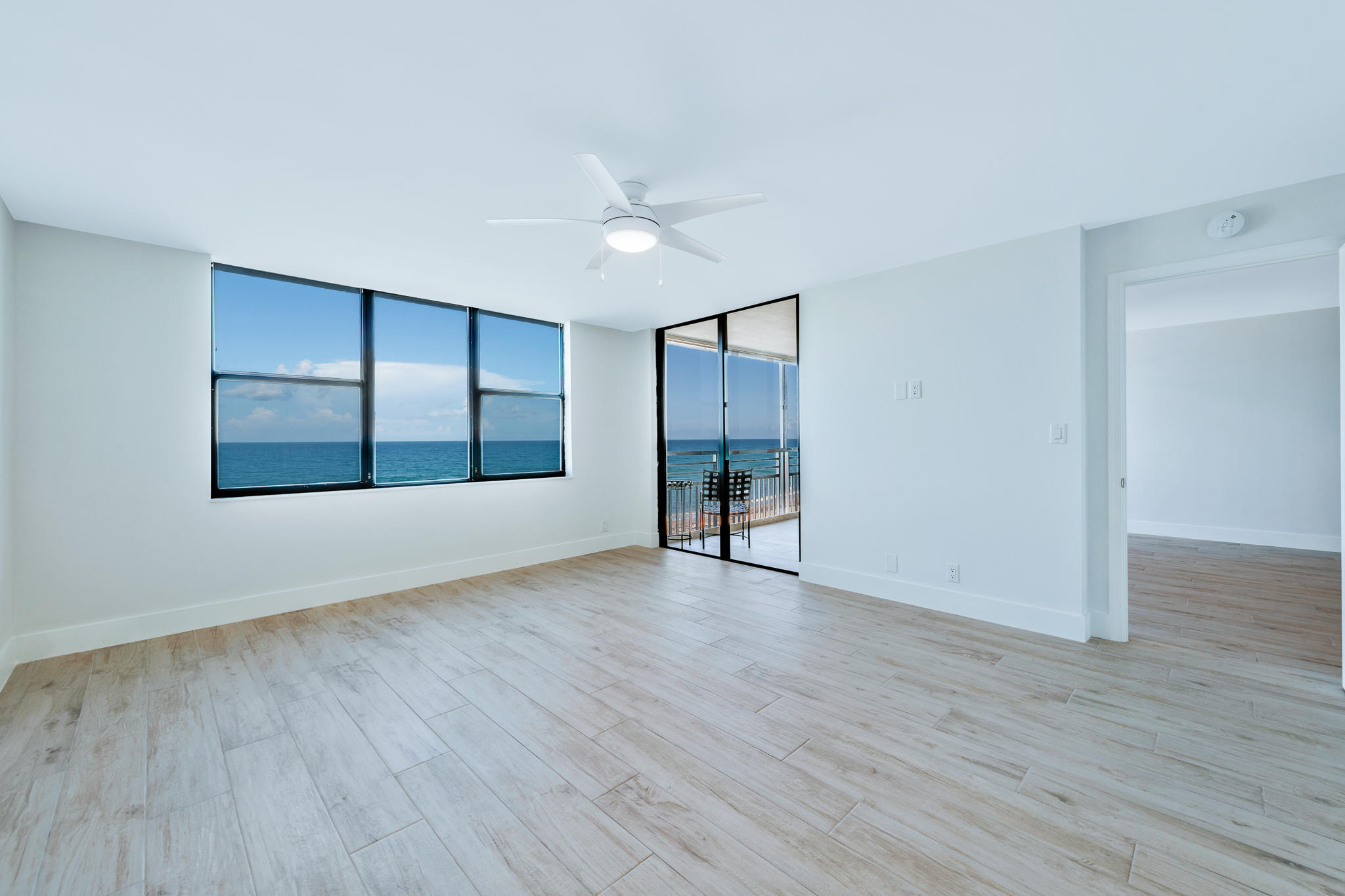 900 Ocean Drive, Unit 403 Juno Beach, FL 33408 - Photo 10 of 15 wooden floor in an empty room with a window