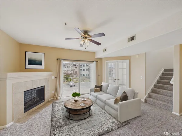 a living room with furniture a window and a fireplace