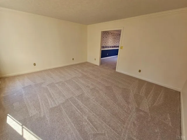 a view of an empty room and a window