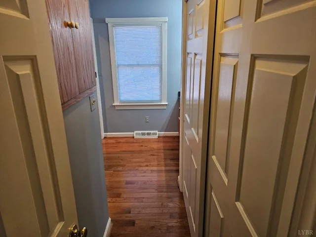 a view of a hallway and wooden floor