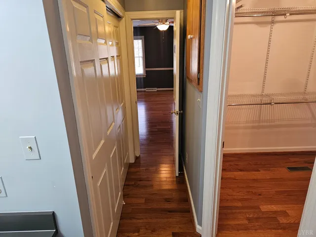 a view of empty room with wooden floor and fireplace