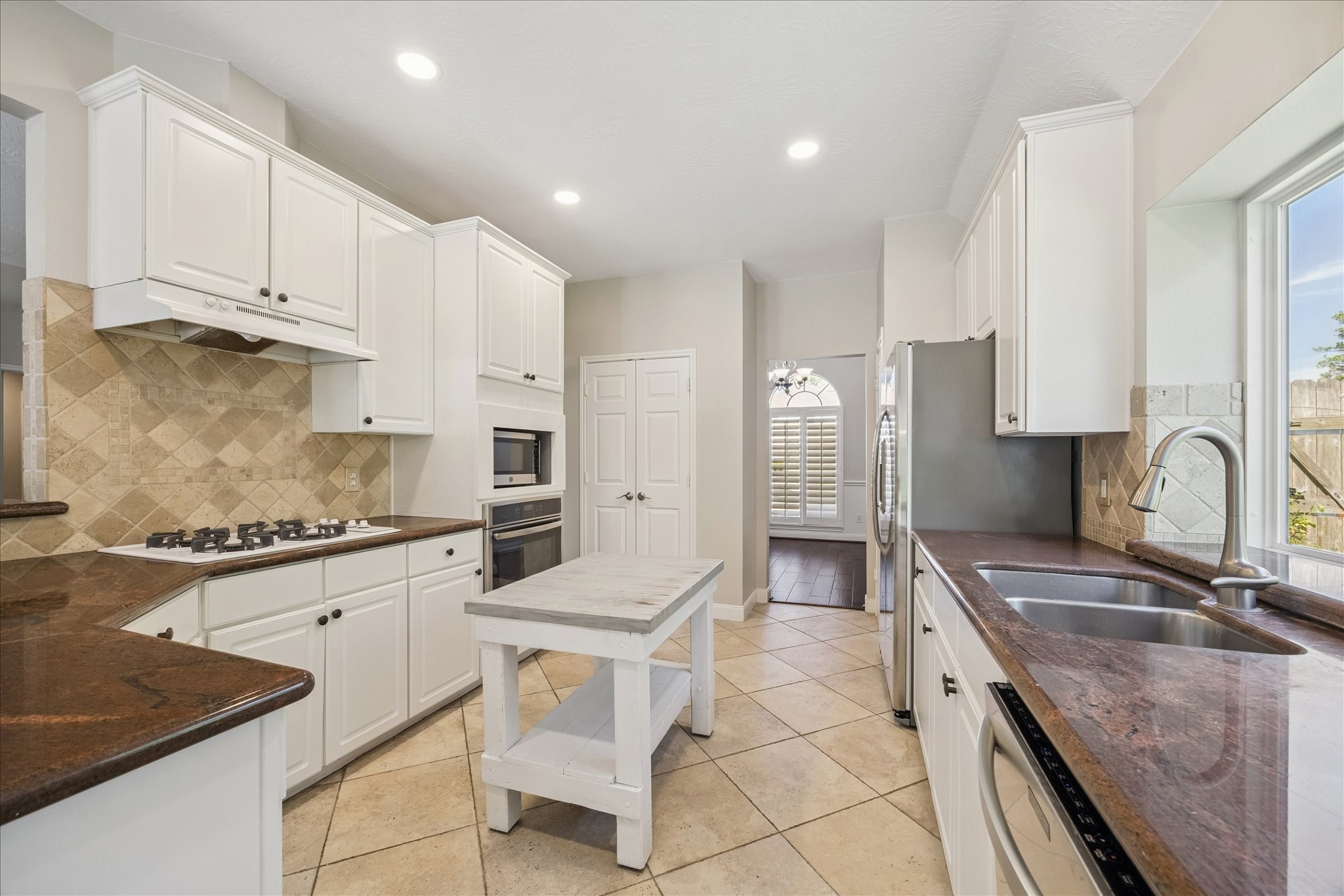 12015 Wynmar Lane Cypress, TX 77429 - Photo 6 of 13 a kitchen with granite countertop a sink stove and cabinets