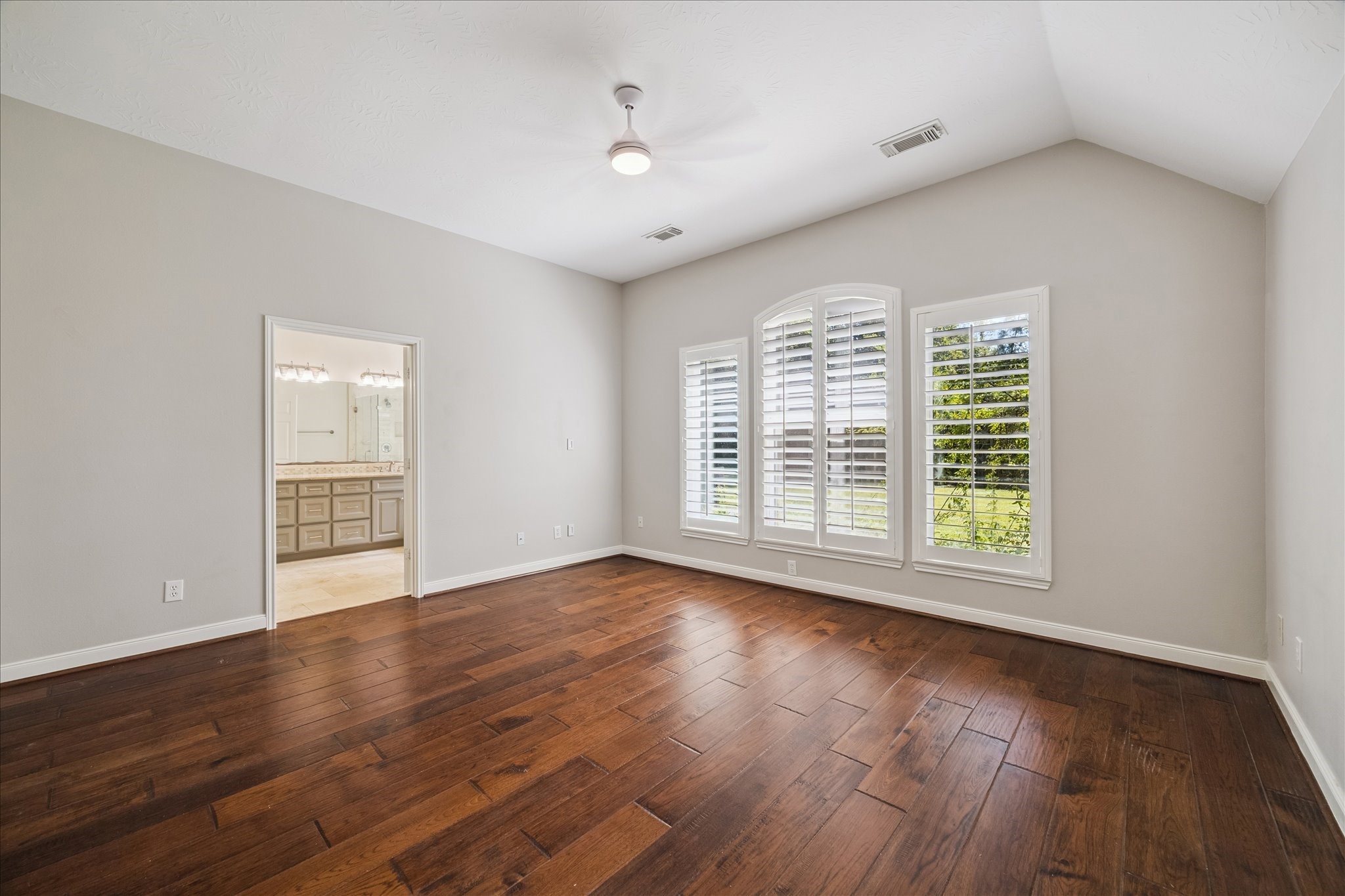 12015 Wynmar Lane Cypress, TX 77429 - Photo 8 of 13 a view of an empty room with wooden floor and a window