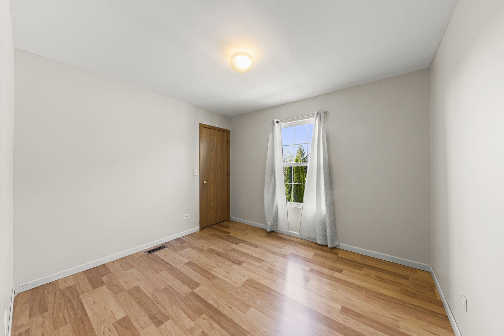 89 Iris Circle Romeoville, IL 60446 - Photo 12 of 28 a view of empty room with wooden floor and fan