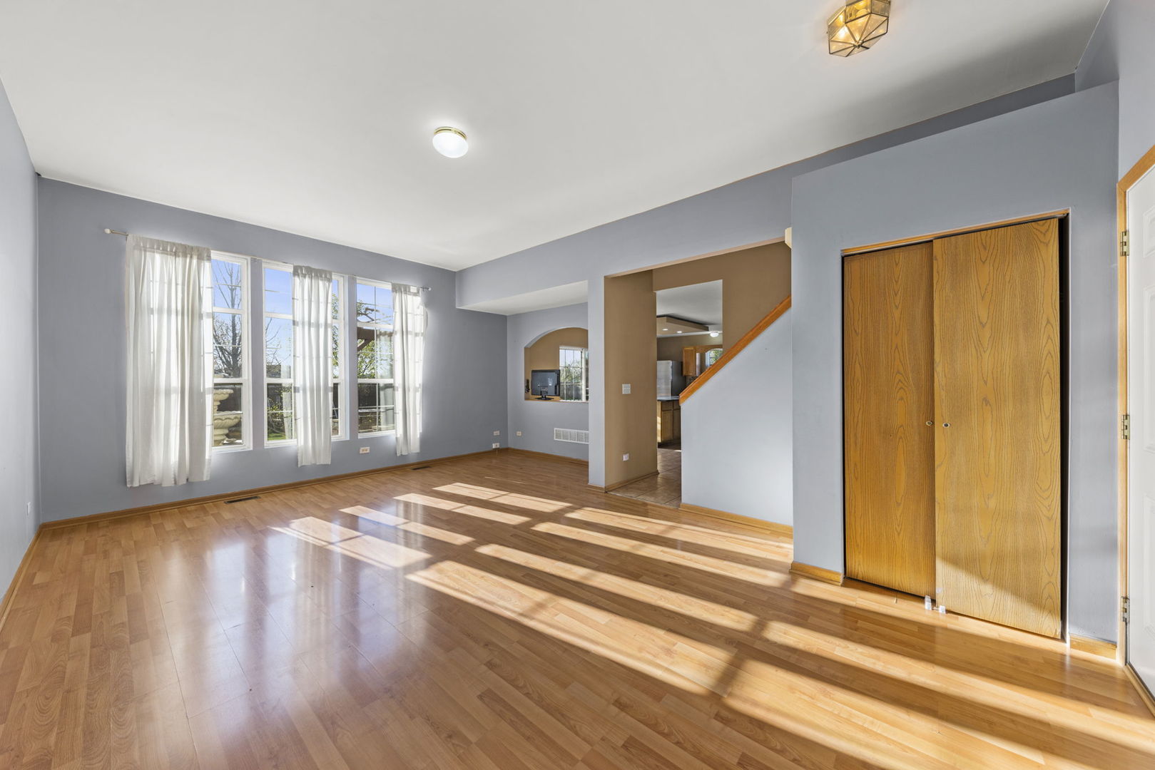 89 Iris Circle Romeoville, IL 60446 - Photo 2 of 28 a view of an empty room with wooden floor and a window