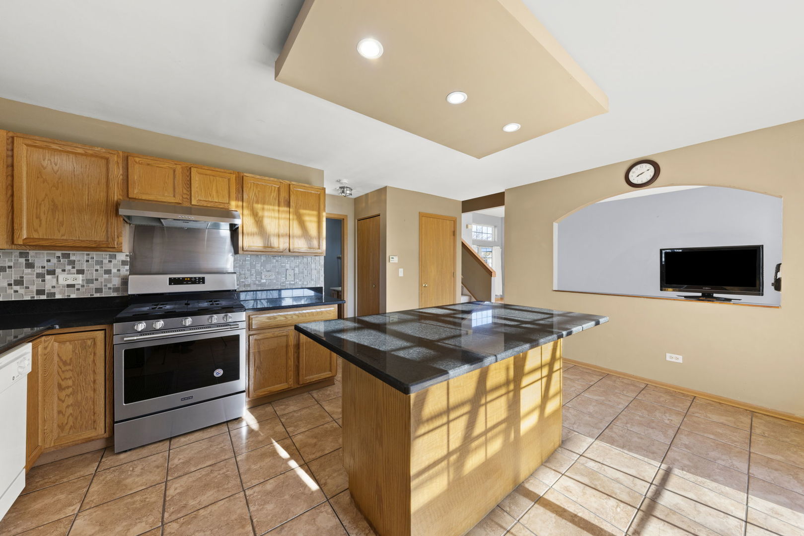 89 Iris Circle Romeoville, IL 60446 - Photo 7 of 28 a kitchen with stainless steel appliances granite countertop a stove a sink and a microwave