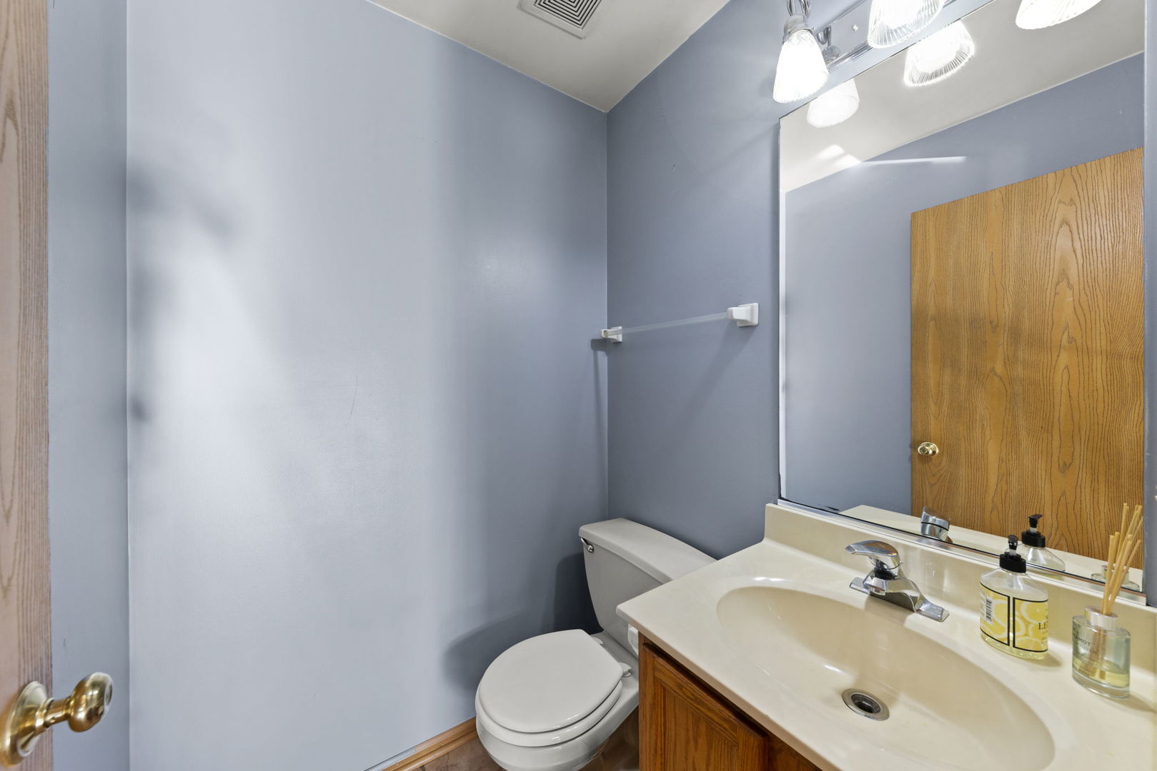 89 Iris Circle Romeoville, IL 60446 - Photo 8 of 28 a white toilet sitting next to a bathroom sink