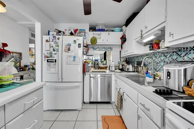 a kitchen with refrigerator and cabinets