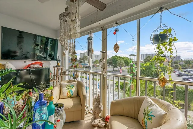a living room filled with furniture and a floor to ceiling window