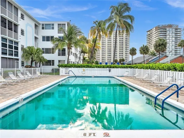 a swimming pool with outdoor seating and yard