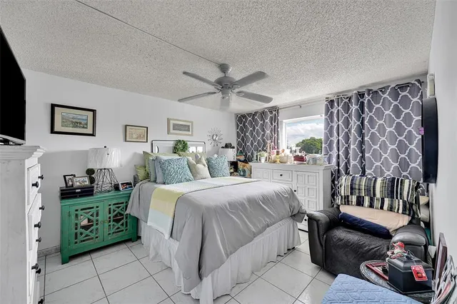 a spacious bedroom with a bed and a couch