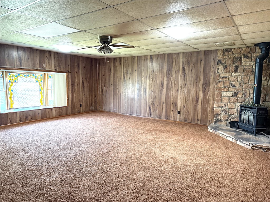 4732 Lehigh Drive Springfield, OH 45503 - Photo 14 of 27 This expansive room features a cozy wood-burning stove and a large window, perfect for comfortable living.