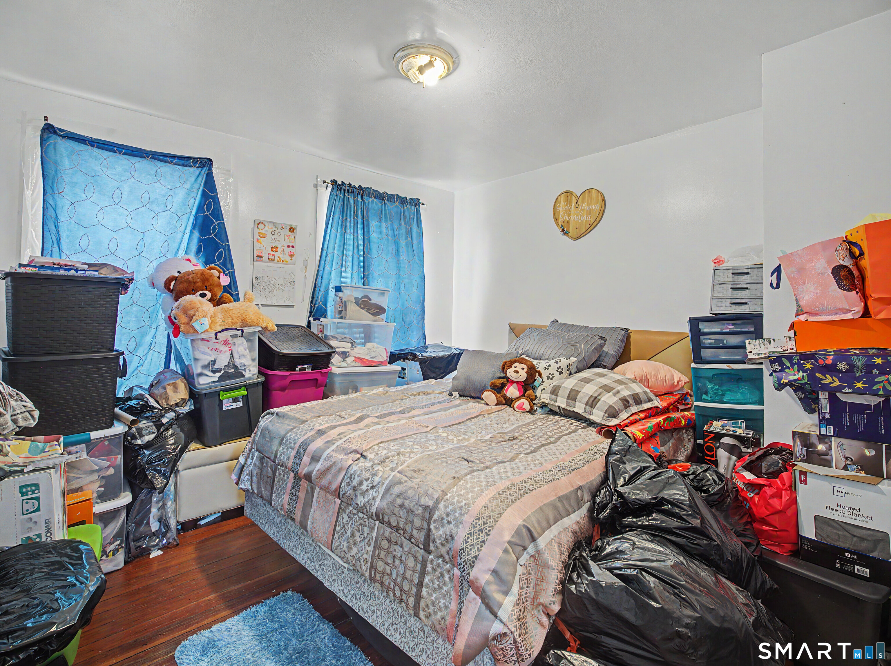 319 Carroll Avenue Bridgeport, CT 06607 - Photo 14 of 40 a bedroom with bed and a chandelier