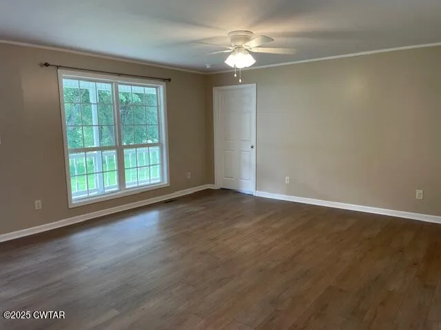 a view of a livingroom with a fireplace a chandelier and wooden floor
