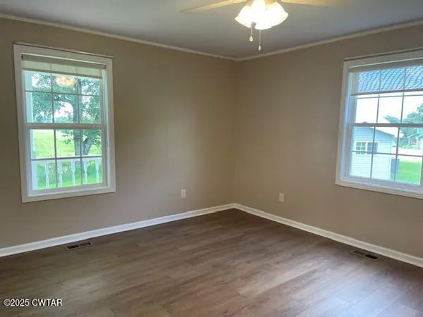 a view of a room with wooden floor