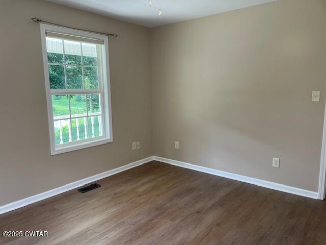 874 Key Road Troy, TN 38260 - Photo 26 of 48 a view of an empty room with wooden floor and a window