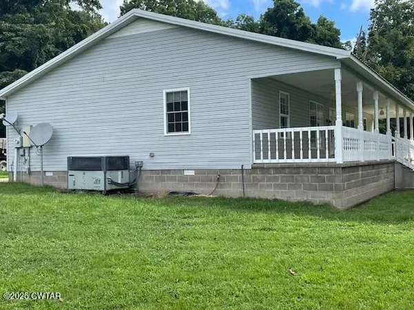 a view of a house with a yard and a garden