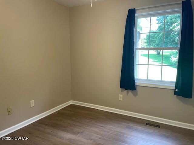 874 Key Road Troy, TN 38260 - Photo 32 of 48 a view of an empty room with wooden floor and a window