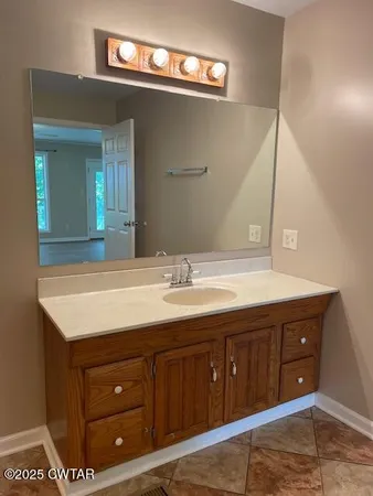 a bathroom with a shower and a sink