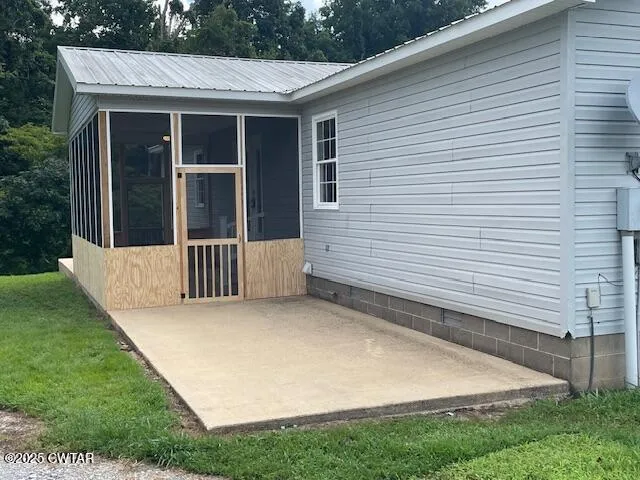 a view of a house with a yard and wooden fence