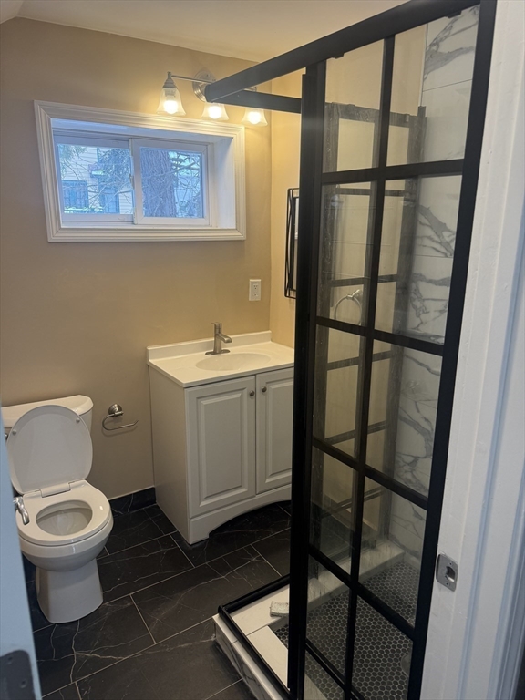 7 Williston Road, Unit A Belmont, MA 02478 - Photo 4 of 10 a bathroom with a toilet sink and a shower
