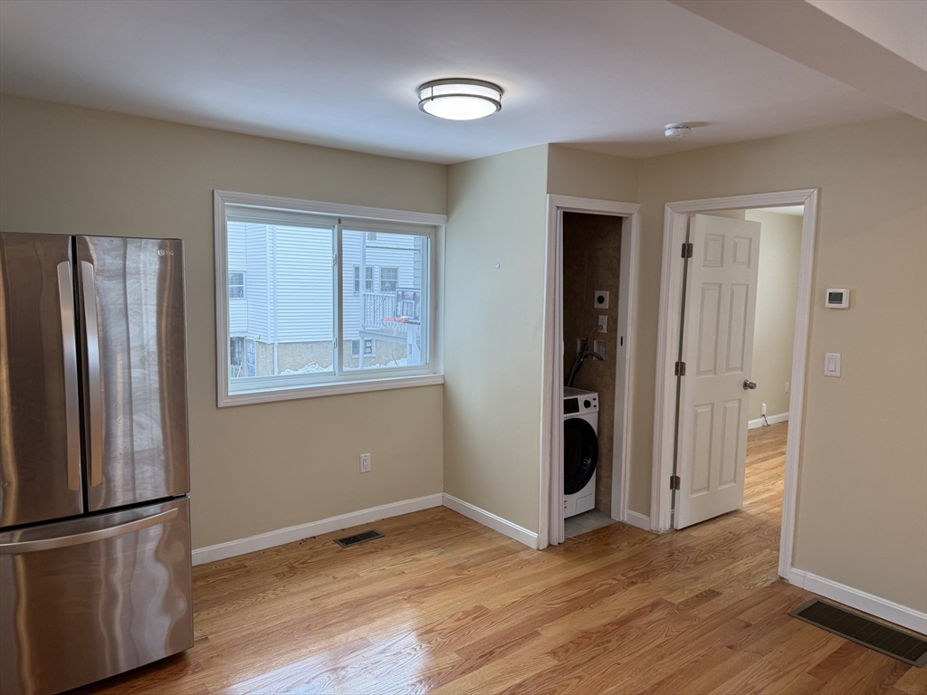 7 Williston Road, Unit A Belmont, MA 02478 - Photo 10 of 10 a view of empty room with wooden floor and window