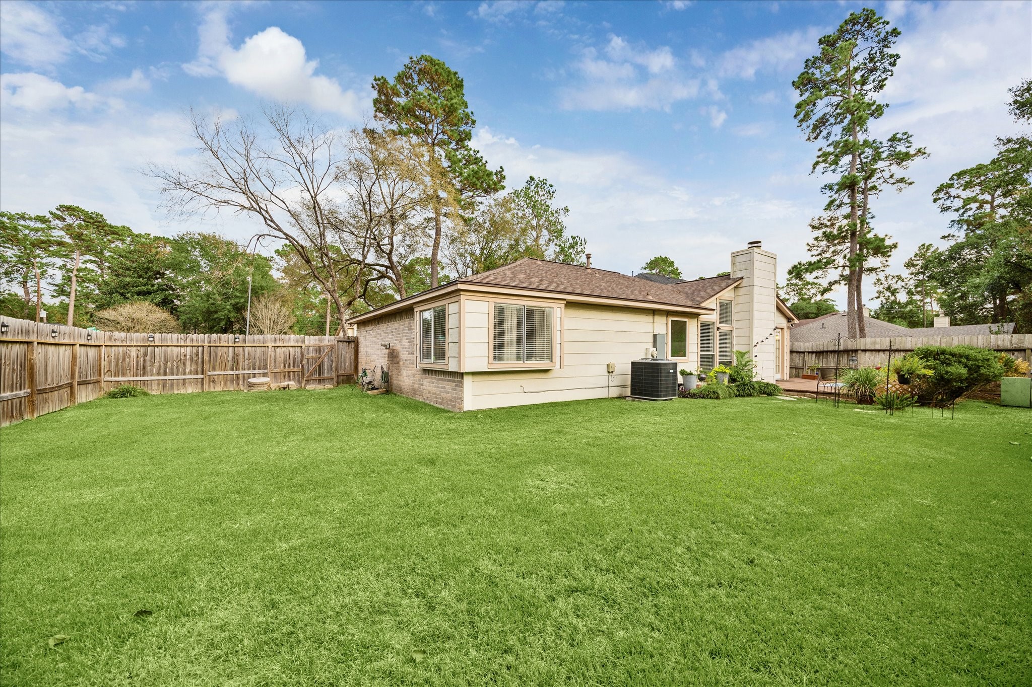 24919 Bovington Drive Spring, TX 77389 - Photo 2 of 21 a view of a yard in front of a house with large trees